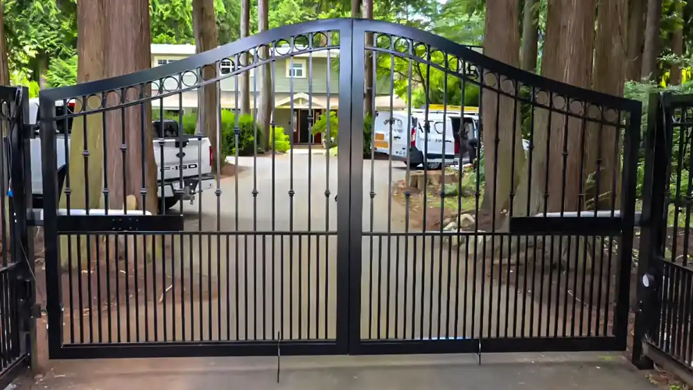 Black double swing ornamental driveway gate with arched top
